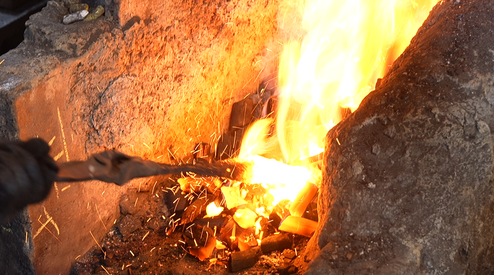 Steel being heated in bright forge flames